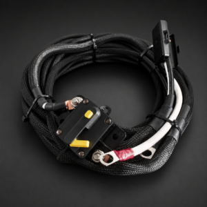 Marine Trolling Motor Power Harness with black braided marine cable, white cable section, ring terminals and breaker on a dark graphite studio background
